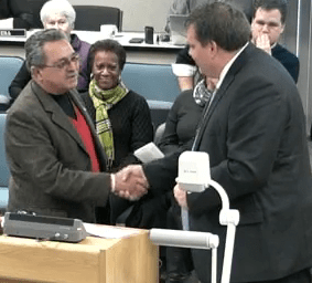 NACAC president Victor Lopez and Mayor Peter Milobar sign agreement today.