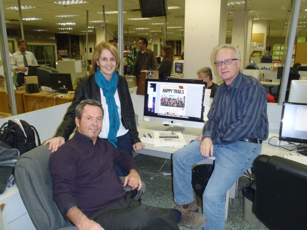 Former editor Susan Duncan, news editor Mike Cornell (sitting) and former editor Mel Rothenburger after front page was completed.