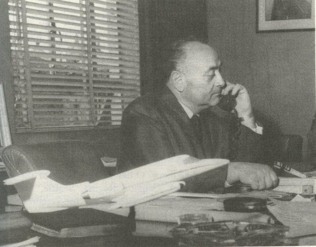 Phil Gaglardi at his desk, with model of Lear jet.