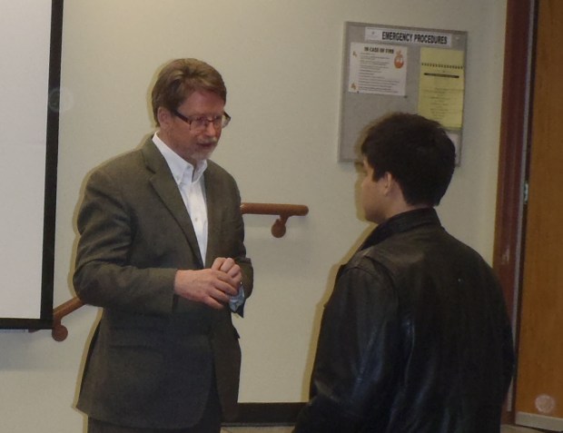 Dr. Paul Evans, left, talks with student after presentation at TRU Wednesday night.