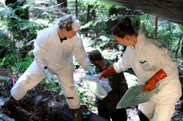 Coroner Courtney Brown (right) and Laurel Clegg of the Department  of National Defence conduct survey near the cockpit earlier in May. (photo by Corp. Brandon O’Connell)