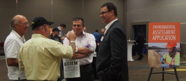 KGHM spokesman Yves Lacasse, right, speaks with members of the public at open house.