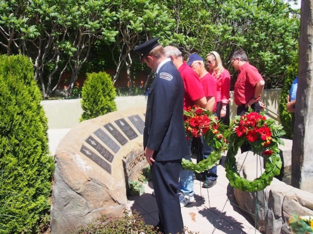 Officers and the public file past the Wall of Honour.