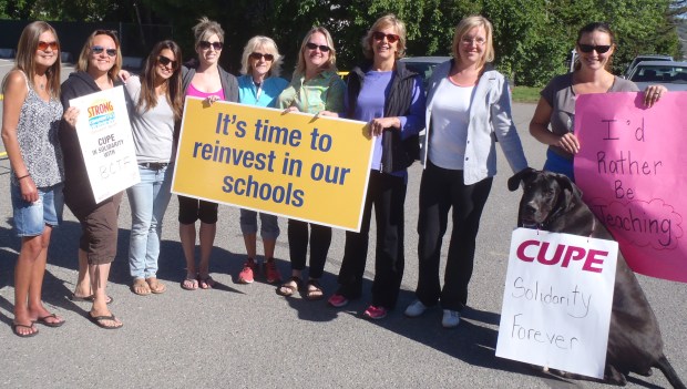 Moses (seated, with CUPE sign) and friends on duty at Arthur Stevenson elementary.
