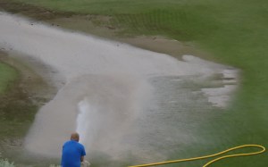 Golf green gets a wash job to remove dirt from runoff.