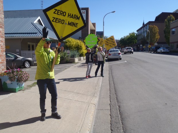 Waving at cars on Seymour Street.