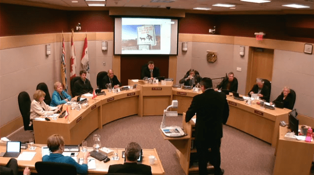 Byron McCorkell shows council new doggie sign for parks.