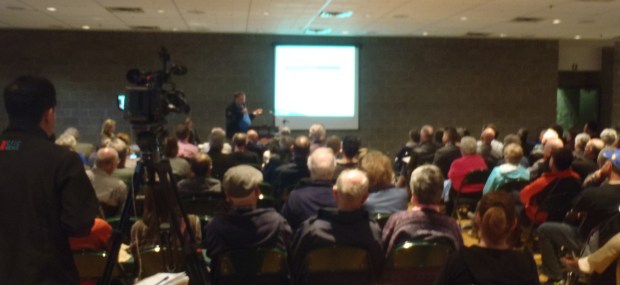 Crowd listens to Mayor Peter Milobar explain costs of proposed arts centre.