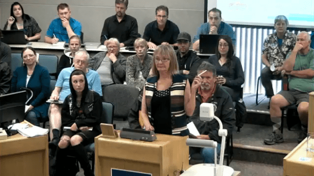 Resident holds up cigarette during discussion of pesticides.