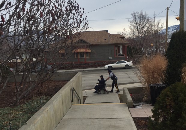 Cst. Sukhdeep Toor lends a helping hand to resident in need of a push home.